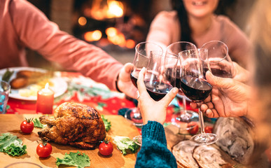 Family toasting red wine and having fun at Christmas supper party - Holiday celebration concept...