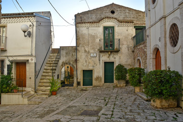 Venosa, Italy, 10/27/2019. A narrow street among the old houses of a medieval village