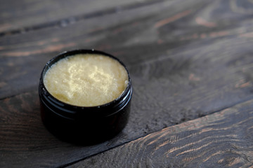Dark brown cosmetic jar with body scrub