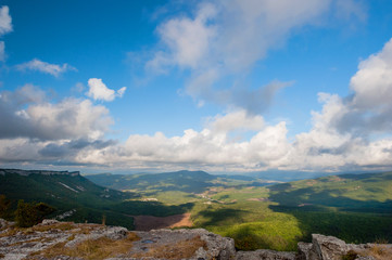 Fototapeta premium Birds view on landscape with mountains and clouds