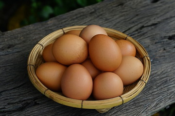 Eggs in basket with wood table background