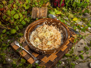 Delicious buckwheat noodles with bacon and seafood in a craft plate