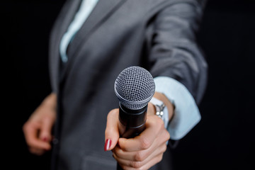 He holds out a microphone .