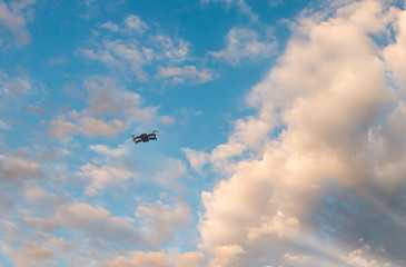 Black drone in the blue sky. Freedom concept