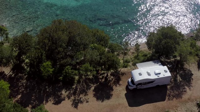 Aerial Footage of Scenic Sea Front RV Campsite. Modern Motorhome Camper Van on the Mediterranean Sea Croatian Coast. Vacation on the Road. Turquoise Bay.