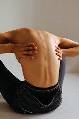 girl in yoga pose, back and spine with hands