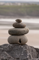 Fototapeta na wymiar Balanced Rock Zen Stack at Lahinch Beach in county Clare. West coast of Ireland. No people, vertical photo. Selective focus.