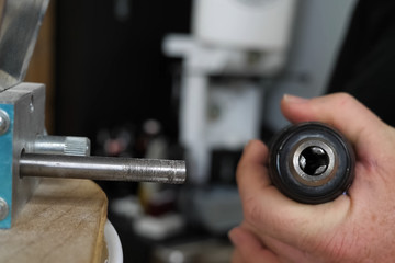 man holds a screwdriver in his hands, preparing for use.