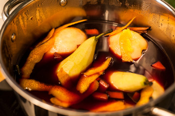 Mulled wine with pears preparing in cooking pot