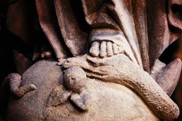 Close up Virgin Mary crushing with her foot the serpent as a symbol of the victory of good over...
