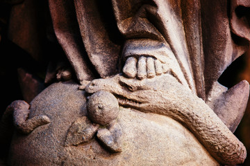 Close up Virgin Mary crushing with her foot the serpent as a symbol of the victory of good over evil.