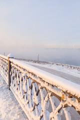 Winter landscape of frosty trees, white snow in city park. Trees covered with snow in Siberia, Irkutsk near lake Baikal. Extremely cold winter