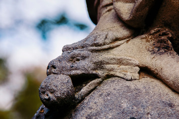 Fragment of ancient statue of Virgin Mary crushing with her foot the serpent as a symbol of the victory of good over evil.