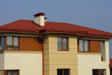 red tile on the roof of the attic of a large private house with a windows