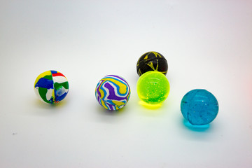 Multi-colored rubber balls on a white background