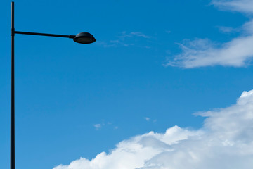 Street lamp in front of sky with clouds