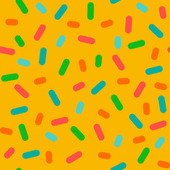 seamless pattern of multicolor confetti particles isolated on yellow. vector