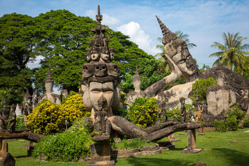 Fototapeta na wymiar Buddha park Xieng Khouane in Vientiane, Laos. Famous travel tourist landmark of Buddhist stone statues and religious figures.