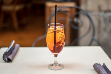 Glass of Aperol Spritz cocktail on the table in a terrace of restaurant