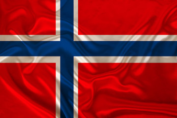 Fototapeta premium photo of the national flag of Norway on a luxurious texture of satin, silk with waves, folds and highlights, close-up, copy space, travel concept, economy and state policy, illustration