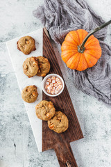 Pumpkin spice truffle cookies on marble and wood serving board