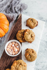 Pumpkin spice truffle cookies on marble and wood serving board