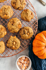 Batch of pumpkin cookies with baking truffles, styled on cooling rack