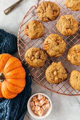 Batch of pumpkin cookies with baking truffles, styled on cooling rack