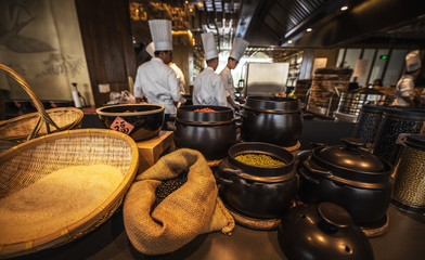 Traditional preparing food and professional Chinese cooks at kitchen.