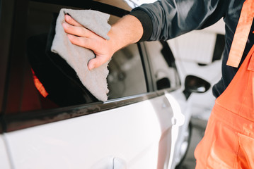 Male hands cleans car interior on carwash station