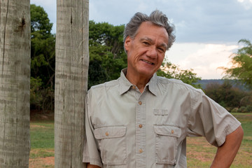 Mature Man hanging out at the park wearing casual clothes 