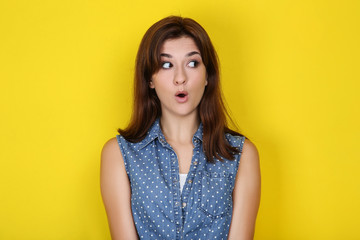Fototapeta premium Young woman in stylish clothing on yellow background