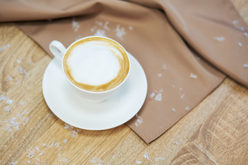 Cup of fresh boiled coffee in cafe with christmas decoration