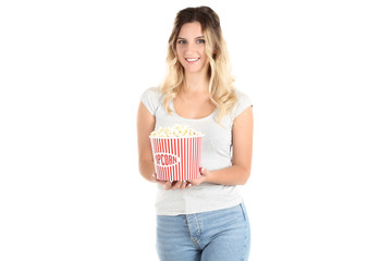 Young woman holding bucket with popcorn on white background