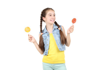 Beautiful young girl with sweet lollipops on white background