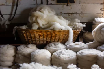 Fotobehang ancient fabric production weaving sheep wool skeins knitting © Nataliia