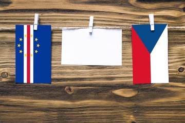 Hanging flags of Cape Verde and Czech Republic attached to rope with clothes pins with copy space...