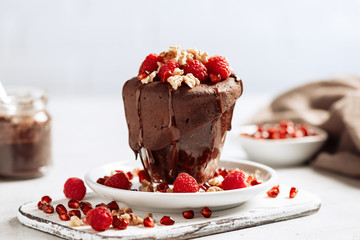 Raspberry mug cake in a glass on light background