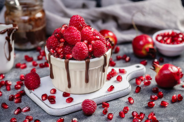 Raspberry mug cake in a red ceramic mug on dark background