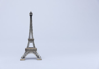 Model of Eiffel Tower on a grey background.