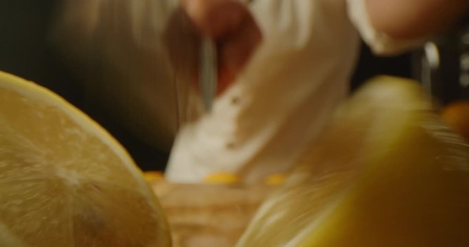 Cutting lemons on half macro shot, yellow citruses, vibrant image, cooking process, slow motion, shot on Red Weapon Helium 8k