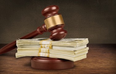 Wooden gavel with money, close-up view