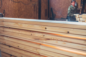 Sorting products at the sawmill - finished wooden building materials - logs and timber