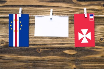Hanging flags of Cape Verde and Wallis And Futuna attached to rope with clothes pins with copy...