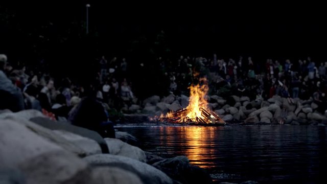 Focused Shot of People Celebrating Midsummer In Front of a Bonfire