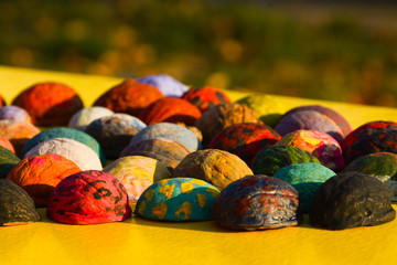 Hand-painted walnuts hell on a yellow open-air table