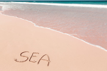 Inscription SEA on sandy beach