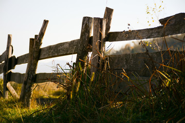 Fototapeta na wymiar Wooden old fence in the village closeup