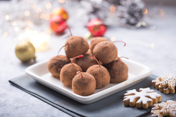 Christmas Sweet candies on the dessert table . Chocolate Balls of biscuit with cherry - loli pop or cake pop. New year decoration and apple cider drink. happy holidey concept