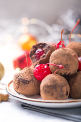 Christmas Sweet candies on the dessert table . Balls of biscuit with cherry - loli pop or cake pop. New year decoration and apple cider drink. happy holidey concept